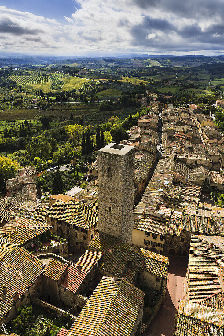 'A stone tower and rooftops; San Gimignano, Tuscany, Italy'