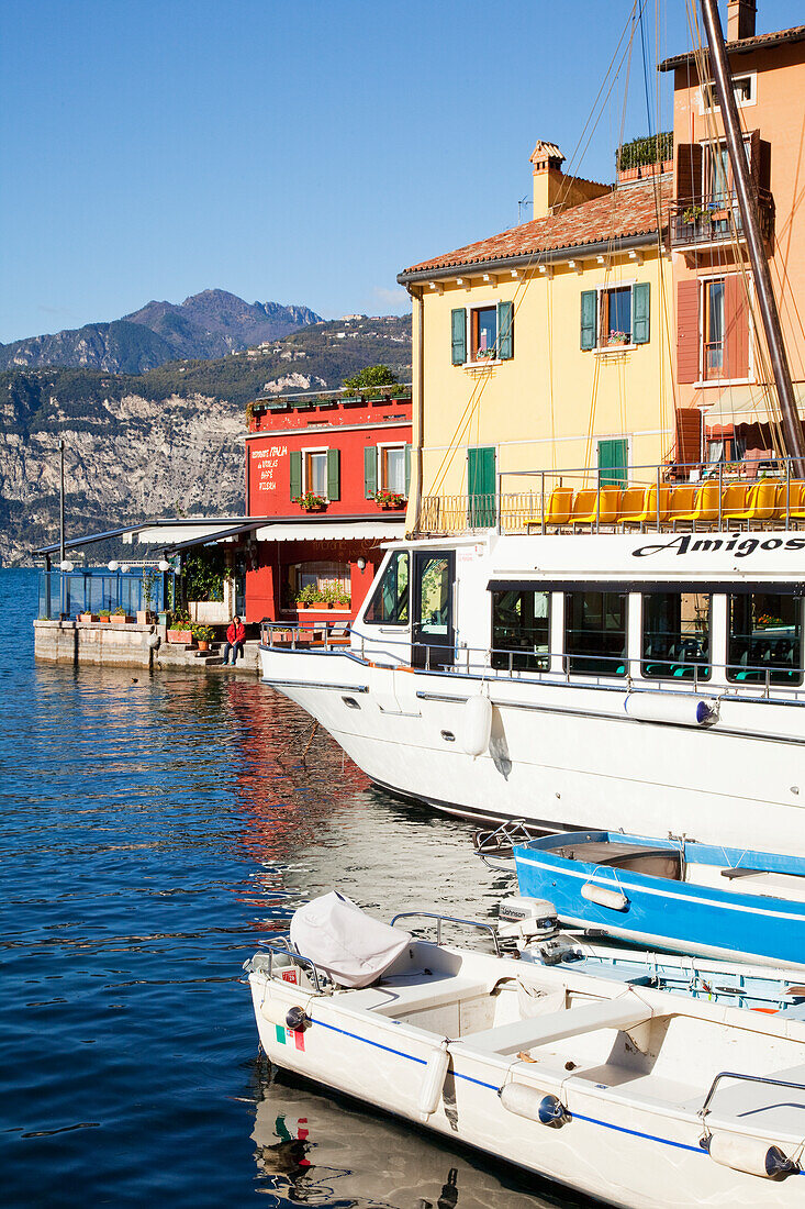 'Boats in the harbour and buildings along the water's edge; Malcesine, Verona, Italy'