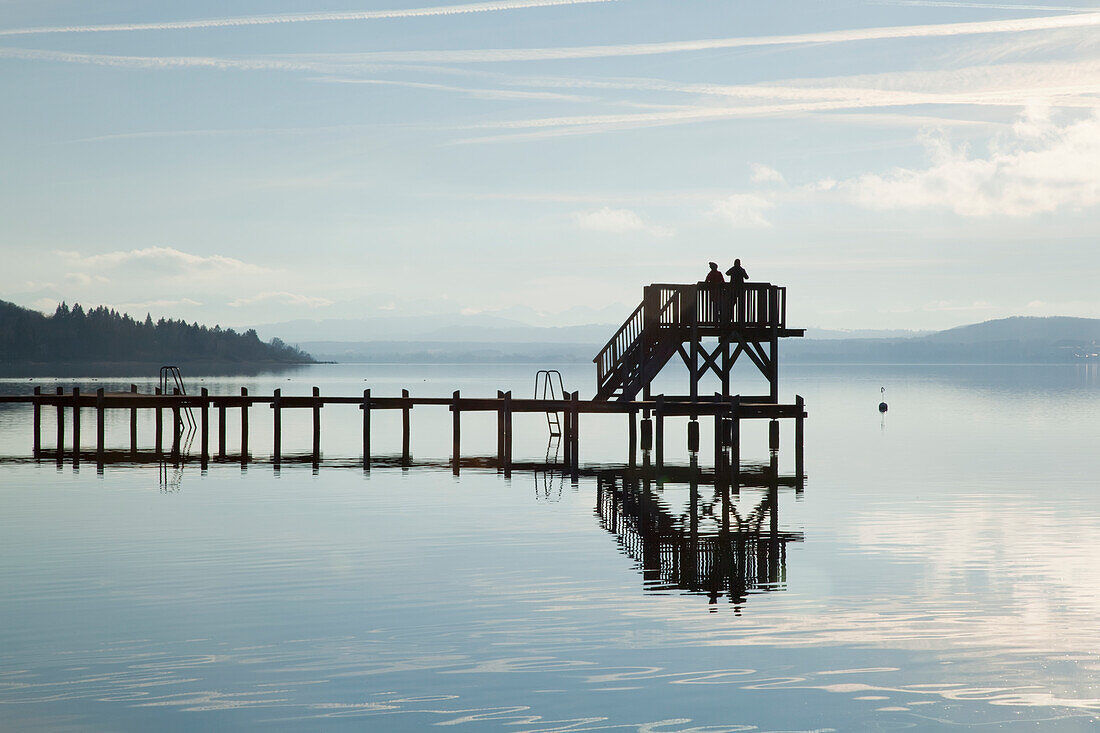 'People on an elevated lookout at the end of a pier on a lake with fog; Herrsching, Bavaria, Germany'