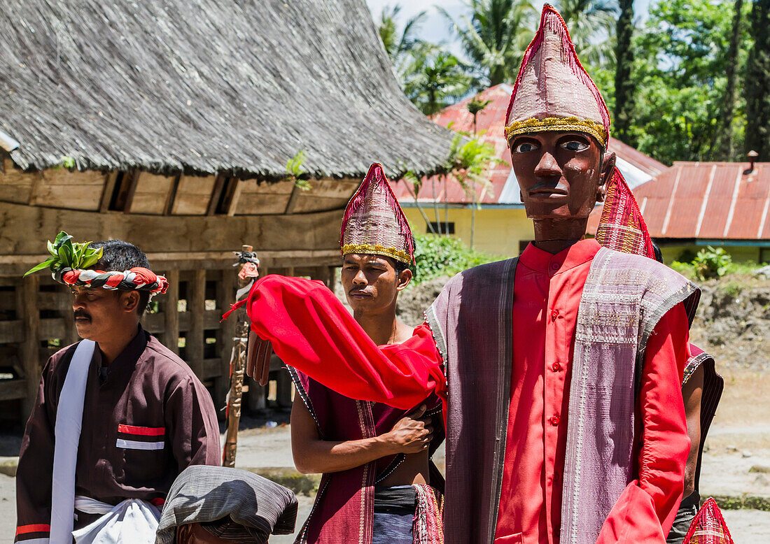 Toba Batak people performing a Sigale Gale puppet dance with a life-sized wooden puppet standing on a platform at Huta Bolon Museum in Simanindo village on Samosir Island, Lake Toba, North Sumatra, Indonesia