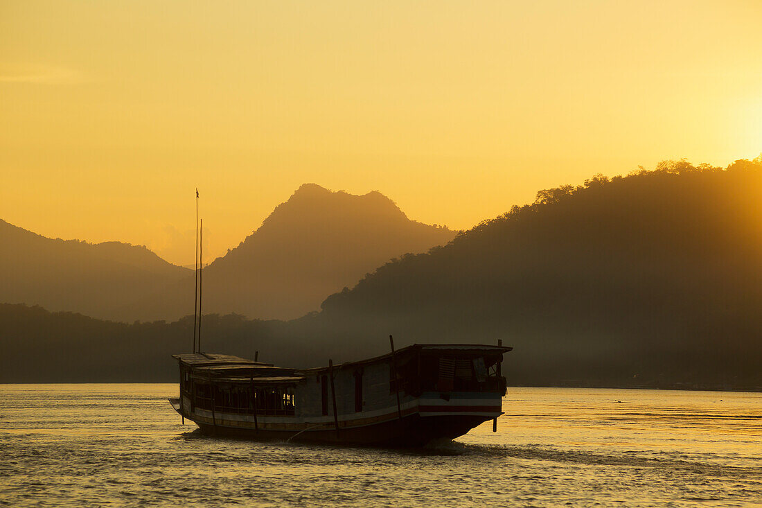 'Boat on the Mekong River at sunset; Luang Prabang, Laos'