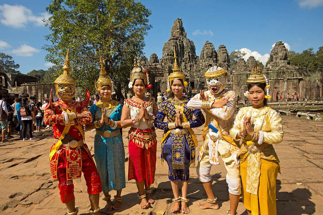 'Traditional dancers in front of 12th century Bayon Temple which is the central temple in Angkor Thom, located north of Angkor Wat; Siem Reap, Cambodia'