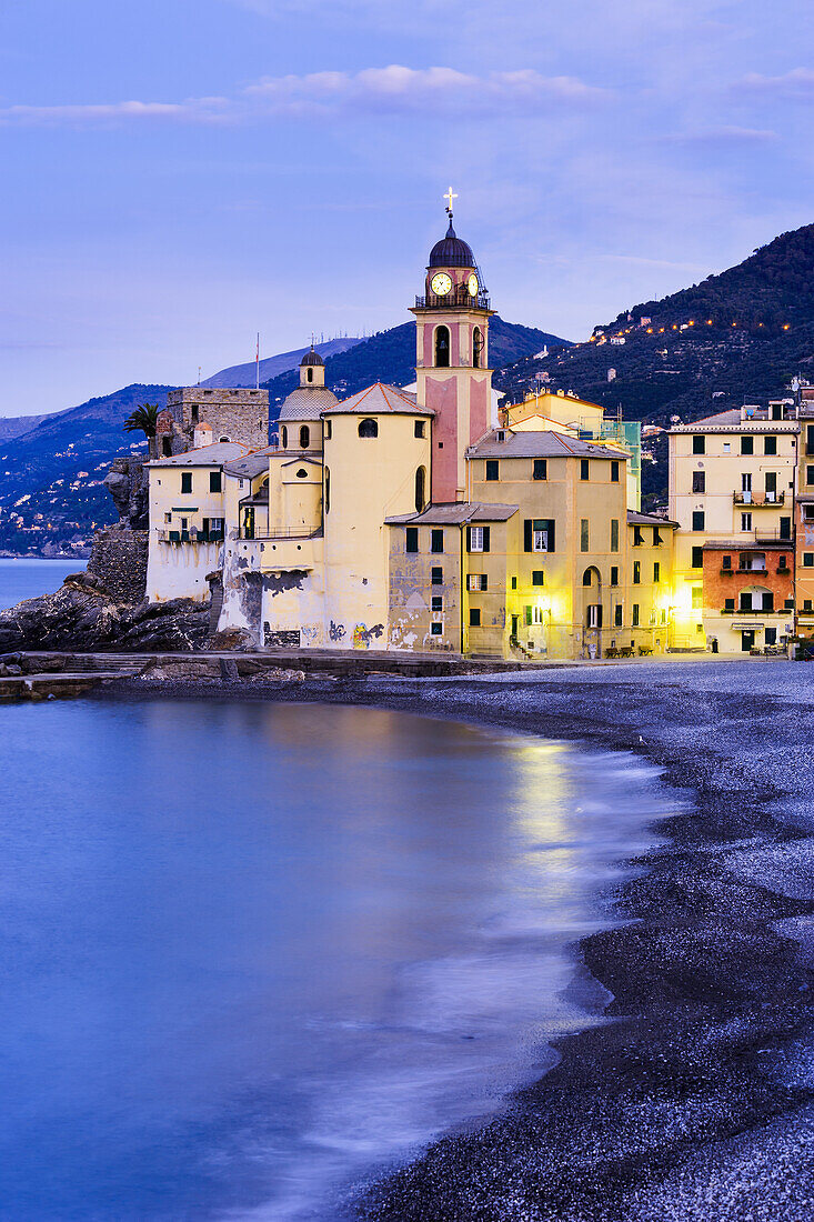 'Buildings illuminated by lights along the water's edge at sunrise; Camogli, Liguria, Italy'