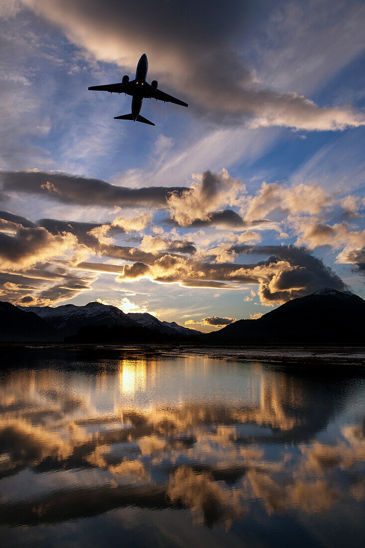 Alaska Airlines jet takes off from Juneau International airport at dawn, Juneau, Alaska.