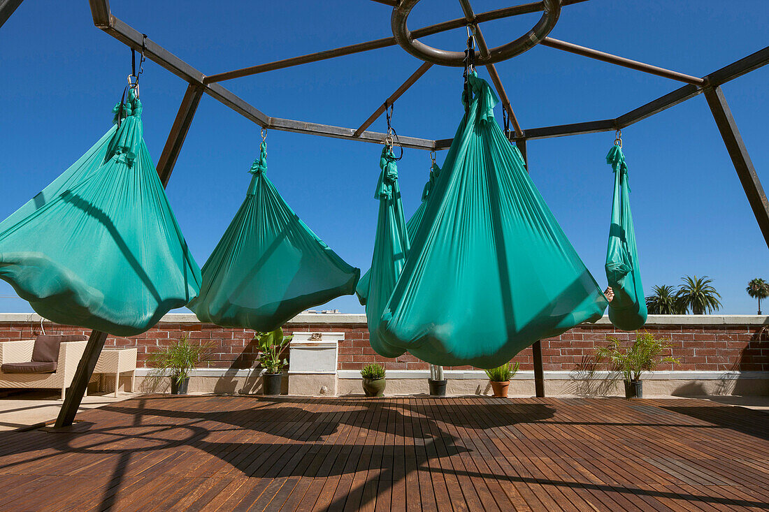 A group of woman perform aerial yoga in San Diego California.
