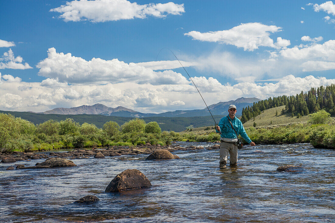 Wading through the river for the next hole high in the mountains of Colorado.