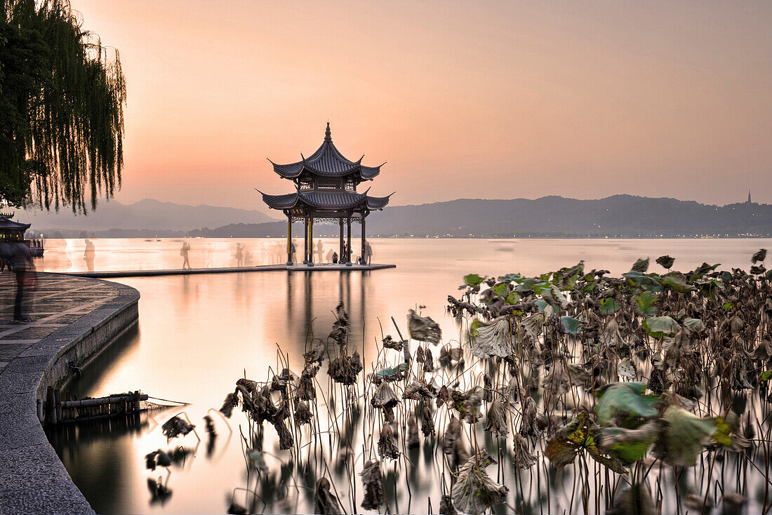 Pagoda at West Lake in Winter, with long exposure ghosting of visitors taking pictures.