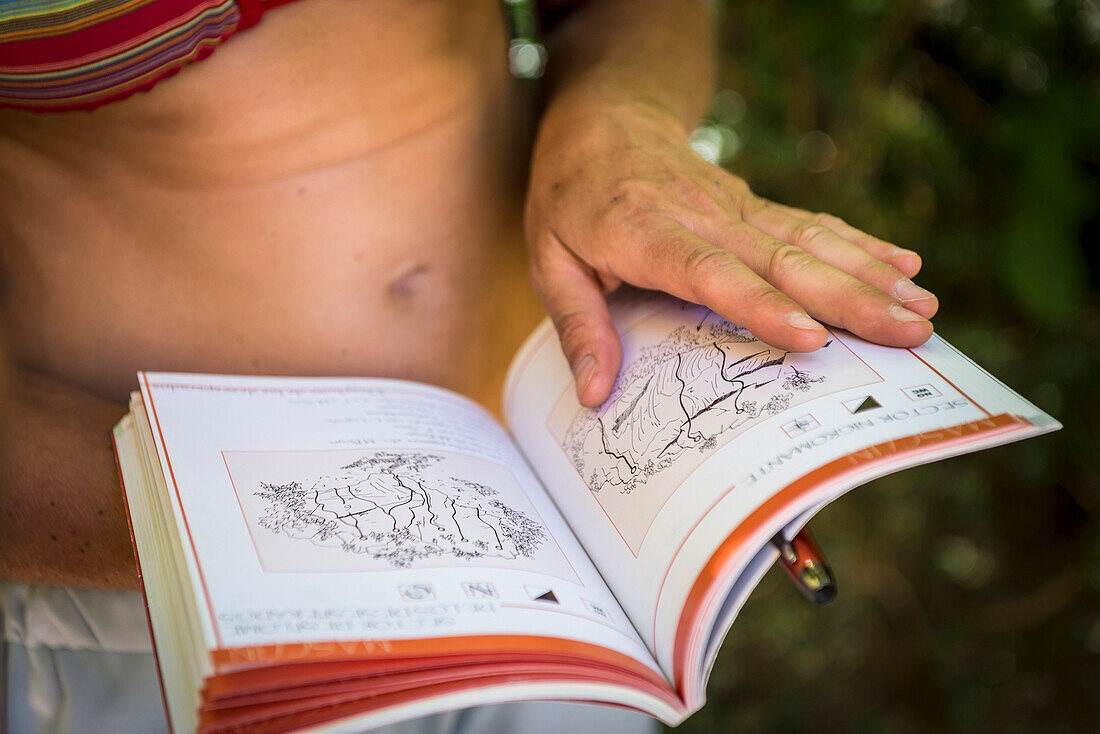 In?™s Couto-Soares, looking at a climbing guide in a summer day at Rodellar, Spain