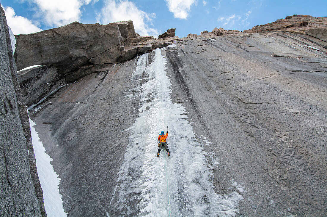A climber leads the first ascent of a difficult ice climb in early fall on 14,000 foot Longs Peak. The floods of September 2013 made for excellent ice climbing in the Colorado High Country.