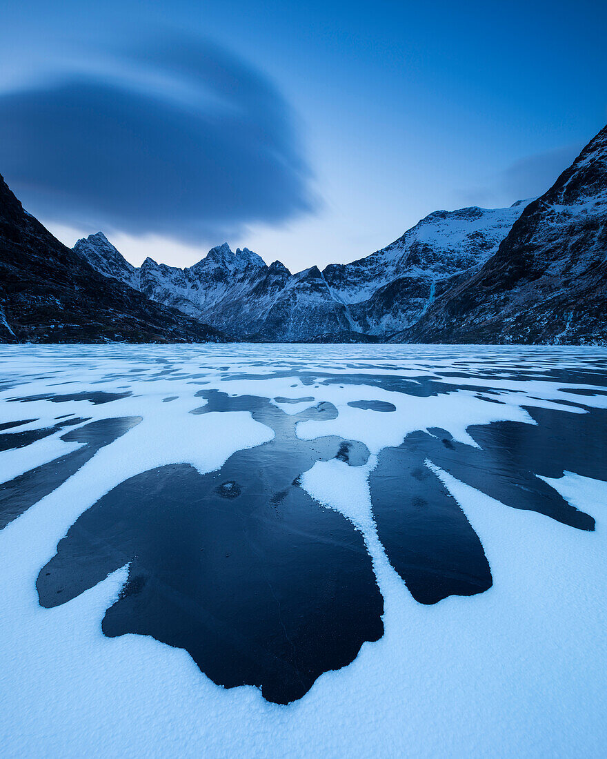Patterns of snow cover black ice of Lake ‚âàgvatnet in winter, ‚âà I Lofoten, Moskenes¬Øy, Lofoten Islands, Norway