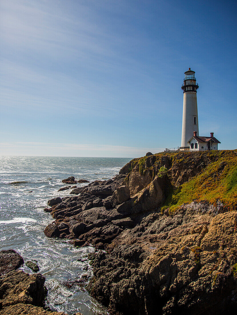 The Pigeon Point Lighthouse near Pescadero, California on a sunny day.