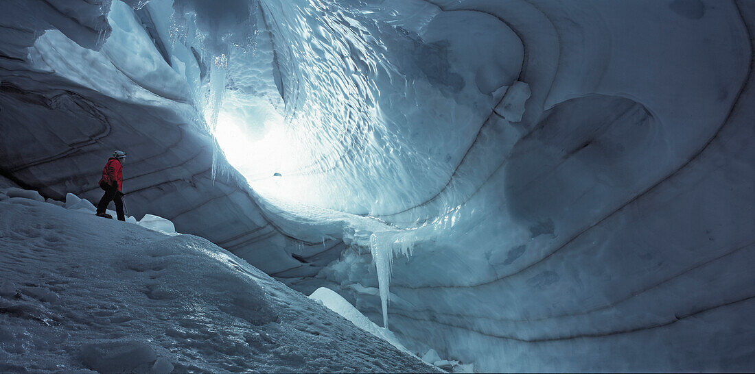 Climber exploring an icecave under the Langjokull glacier in west Iceland