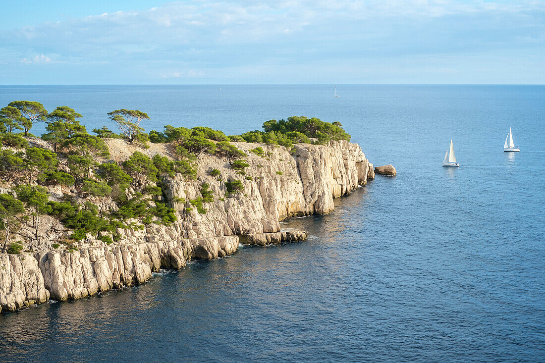 Sailboats passing the entrance of Calanque de Port-Pin