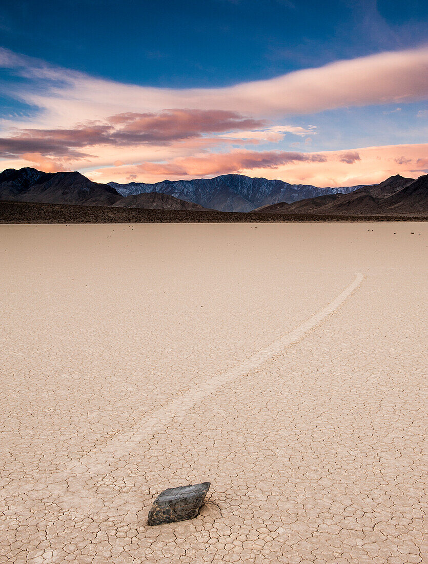 Sunrise colors above moving rock at the Race Track