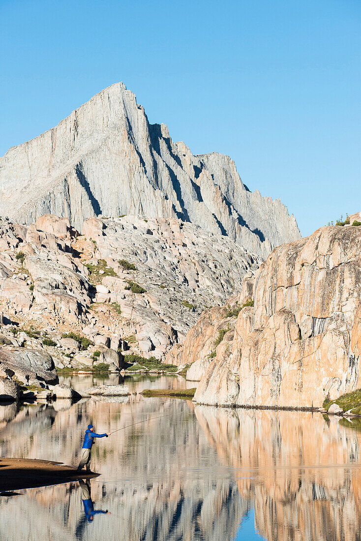A man tries his hand at a little early morning fly fishing in the High Sierra