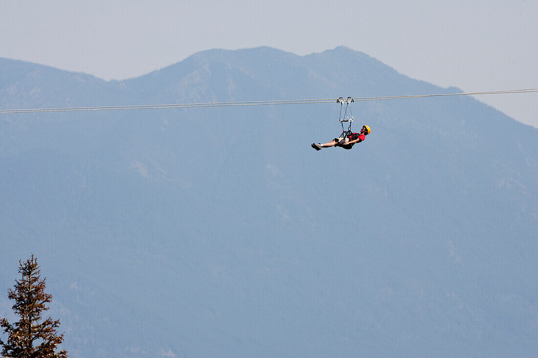 A woman on a zip line.