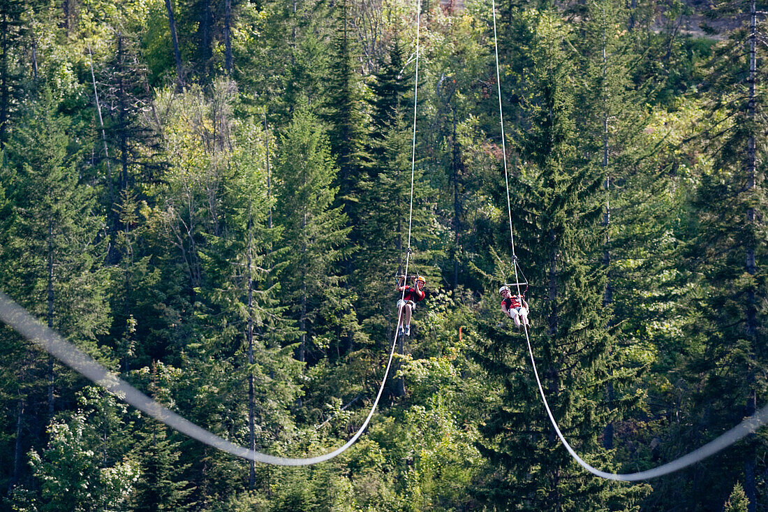 Two women on a zip line in Whitefish, Montana.
