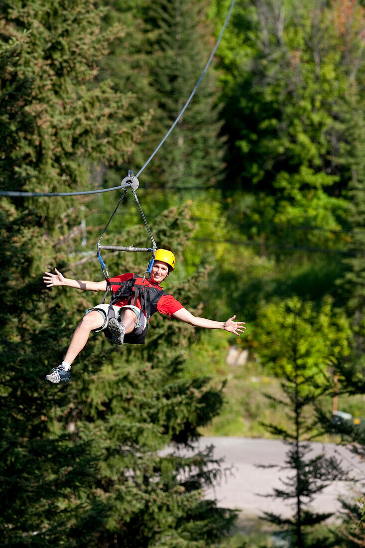 A woman on a zip line tour in Whitefish, Montana.