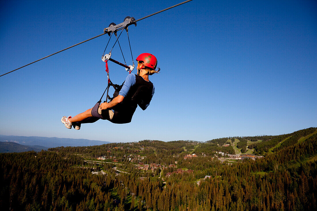 A woman on a zip line tour in Whitefish, Montana.