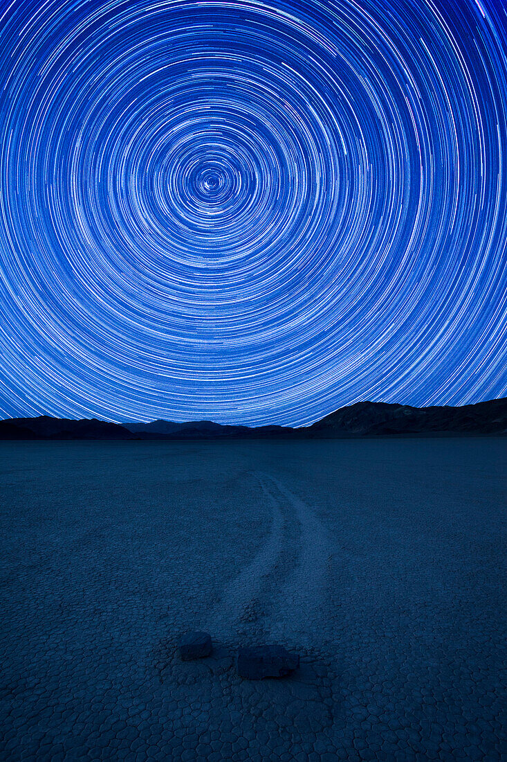 'Circular star trails around the north star above the ''racing'' stones of Death Valley National Park'' Racetrack Playa  in California.'