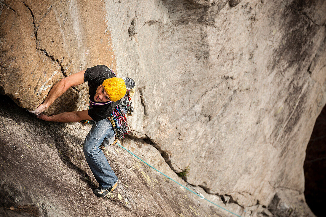 Man lead climbing a two pitches crack route in trad style, where only friends and nuts are allowed to protect the progression. Cadarese is a granite crag located in Premia, Ossola Valley, and is growing to one of the best european destination for trad and
