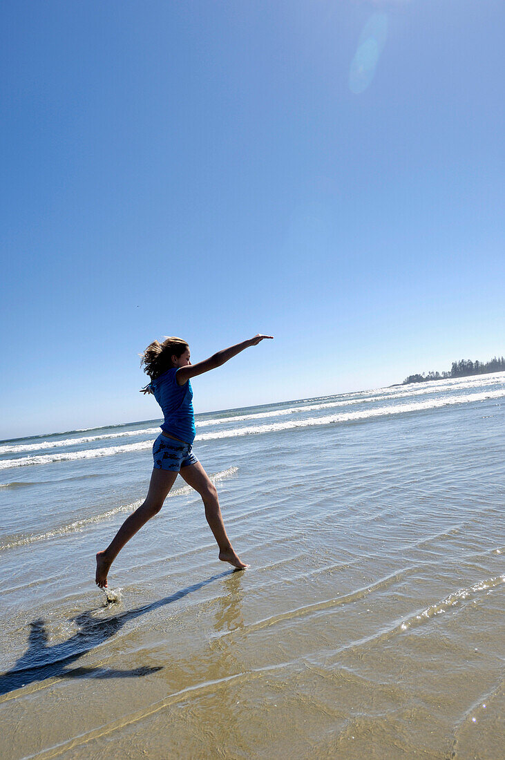 Pre-Teen Girl Running On Beach, Vancouver Island, B.C.