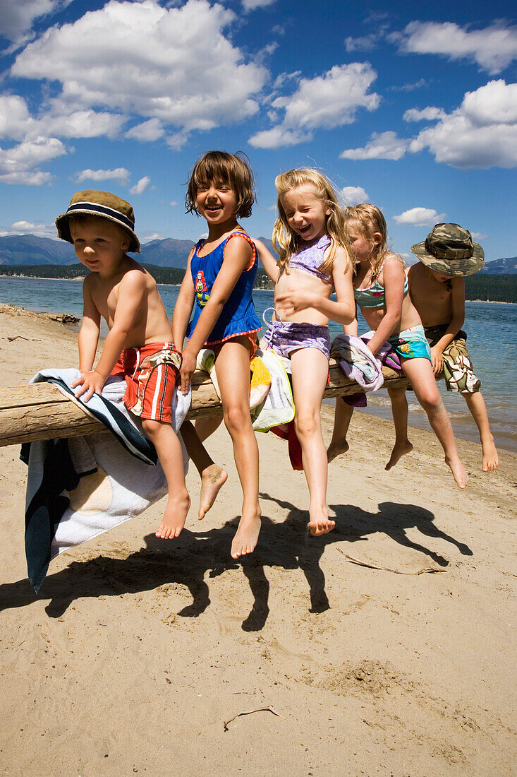 Children Playing On Beach On Lake Koocanusa In The East Kootenays Near Fernie, British Columbia, Canada