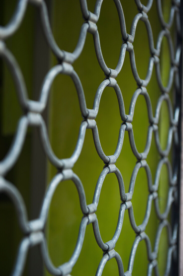 'Chain link fence and a green wall; Barcelona, Spain'