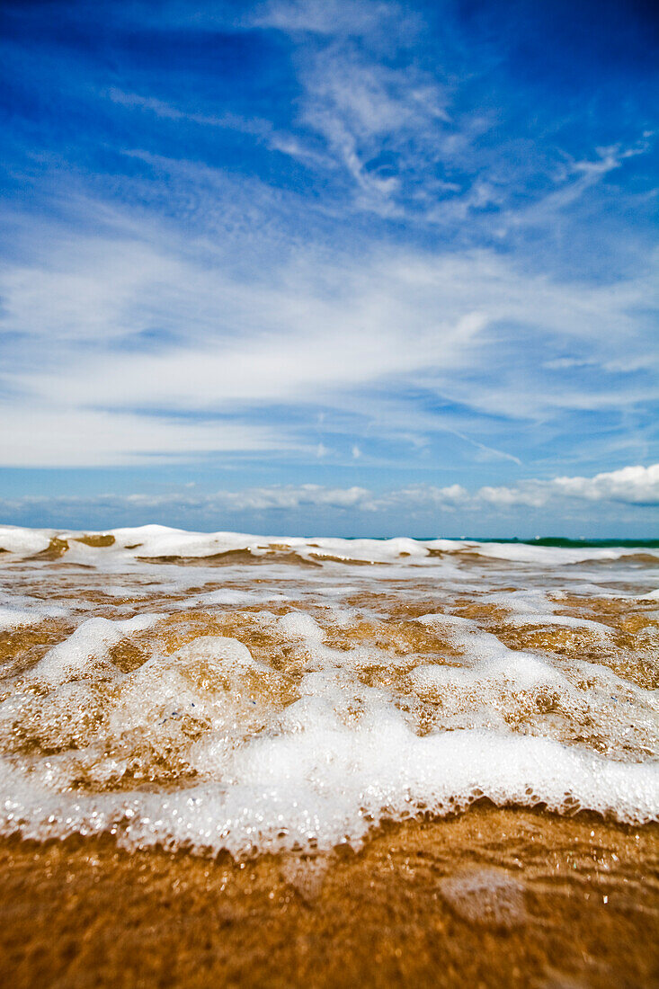 Sea washing in onto sandy beach