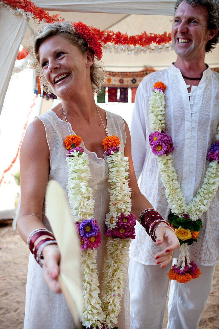 Western couple have a spiritual wedding ceremony at Harmonic Healing Centre, Patnum, Goa, India.