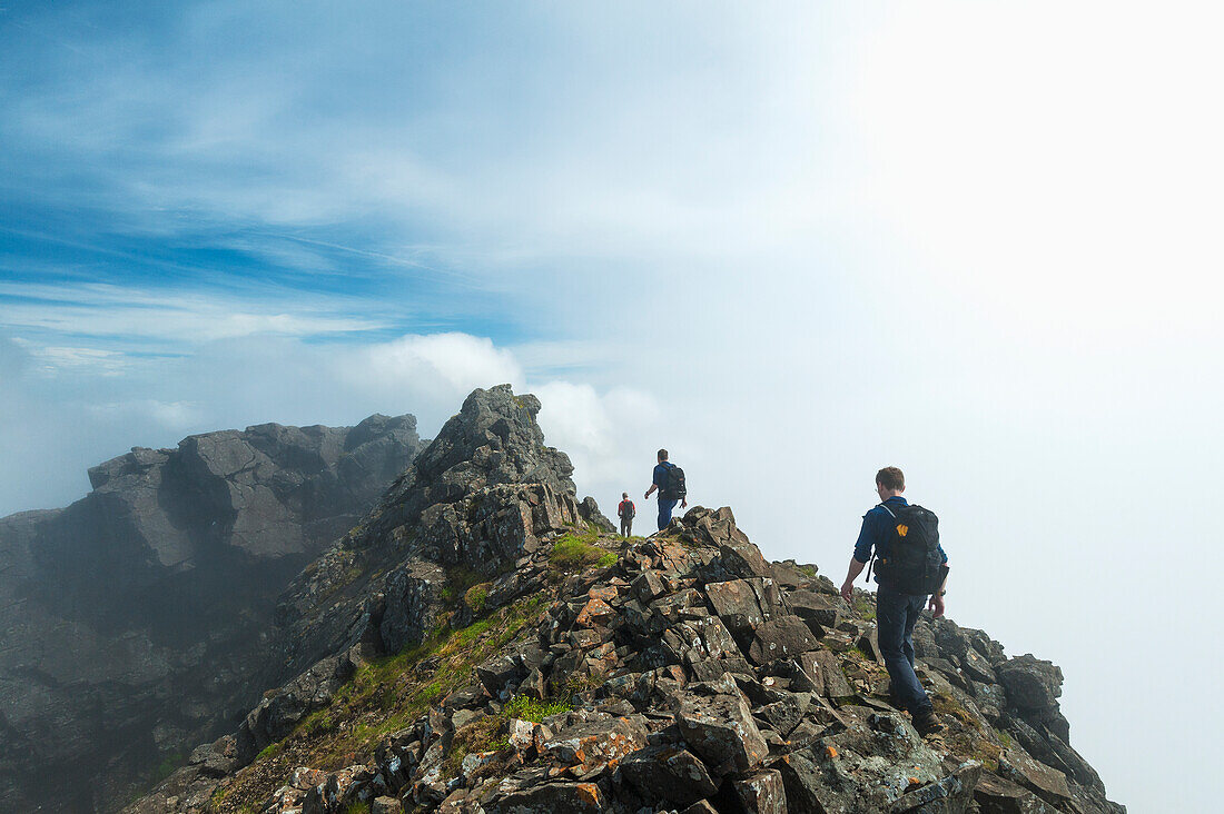 'Walkers on ridge near the top of Sgurr Alasdair in the Black Cuillin; Isle of Skye, Scotland'