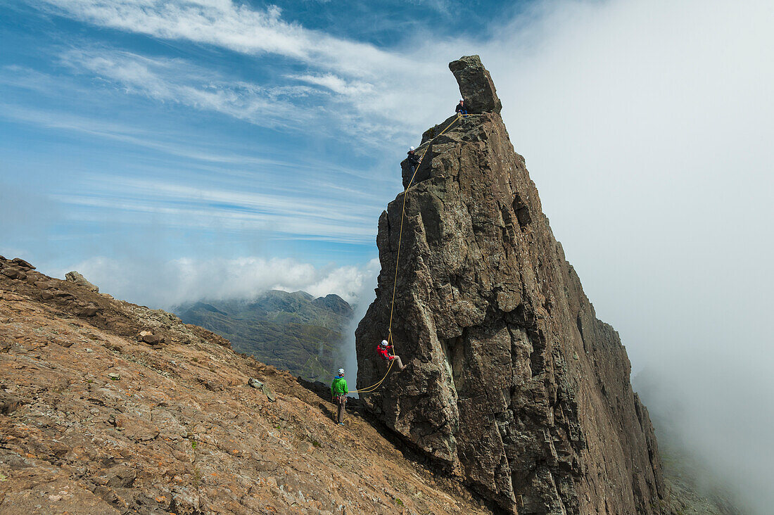 'People abseil off the Inaccessible Pinnacle at the summit of Sgurr Dearg; Isle of Skye, Scotland'