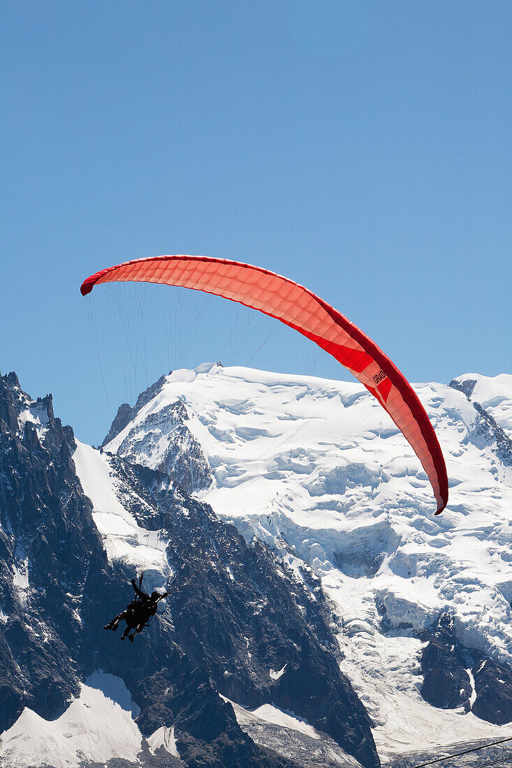 'Tandem paraglider flight above Chamonix-Mont Blanc valley, with Mont Blanc mountain in background; France'