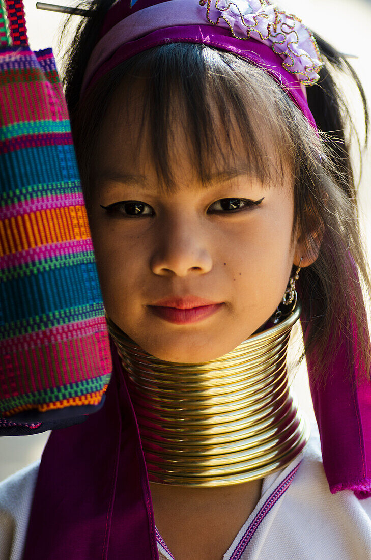 'Portrait of a young woman from the Long Neck Karenni hill tribe; Thaton, Chiang Rai, Thailand'