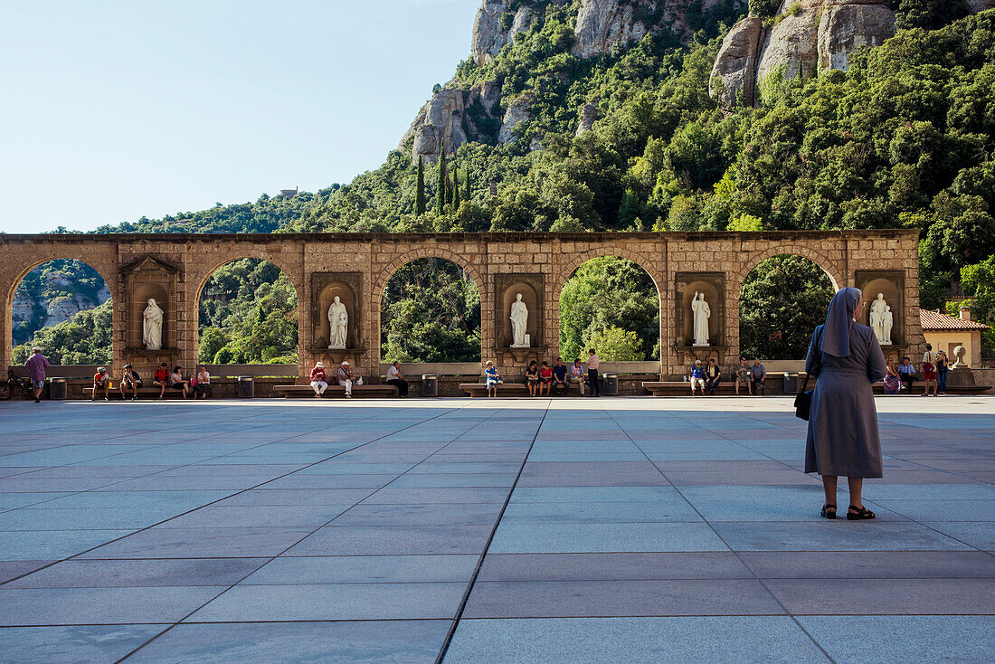 'A nun standing outside the Benedictine Abbey; Montserrat, Catalonia, Spain'