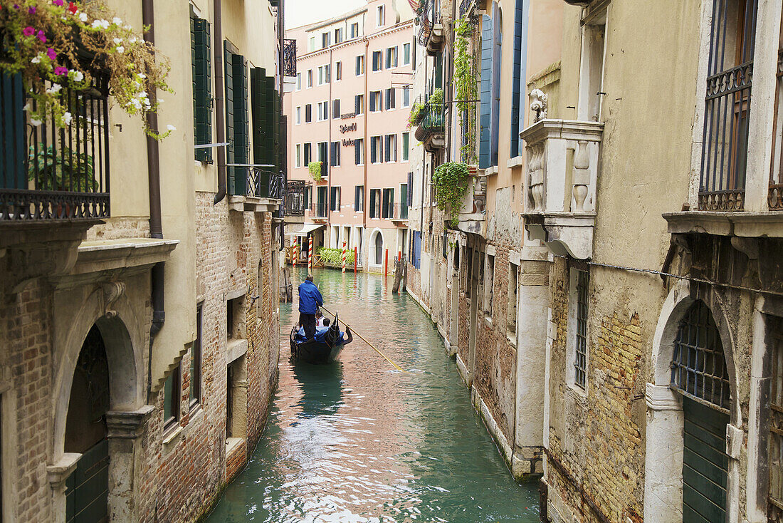 'Gondolier on canal in Venice; Venice, Veneto, Italy'