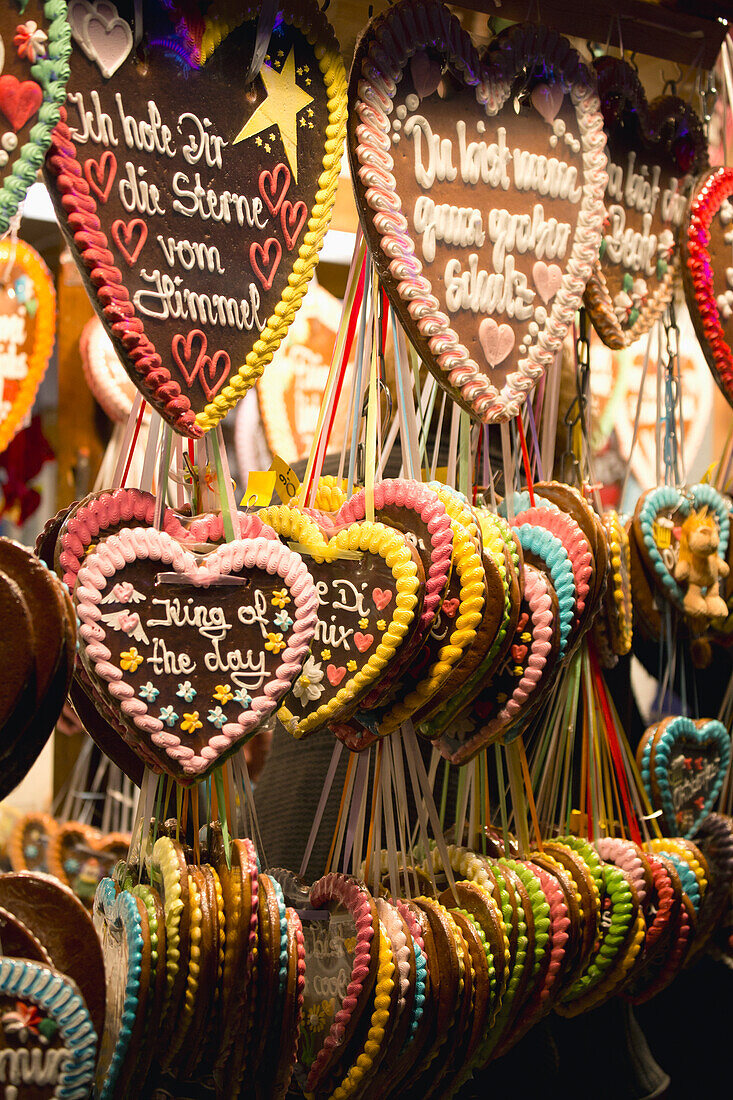 'Heart shaped decorative cookies hanging on display with written verses; Munich, Germany'