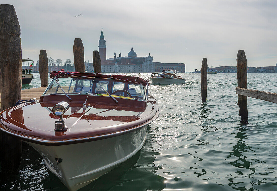 'Motorboats in the Grand Canal with buildings along the shoreline in the distance; Venice, Veneto, Italy'