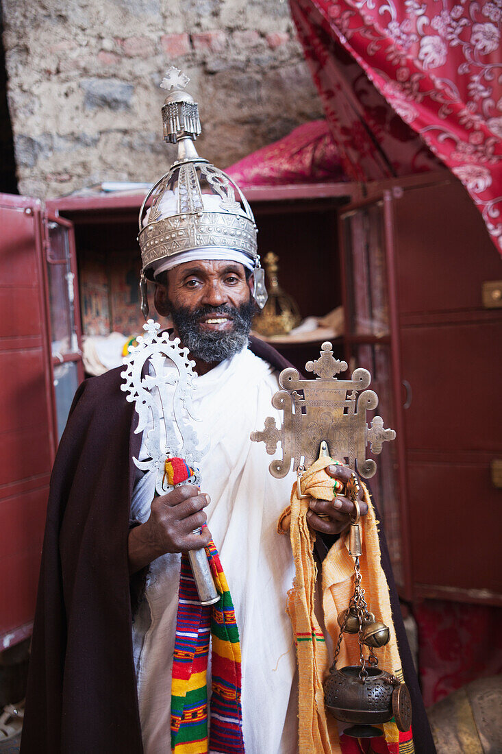 'Priest with crown and crosses, Nakuta Laab monastery, near Lalibela; Amhara region, Ethiopia'
