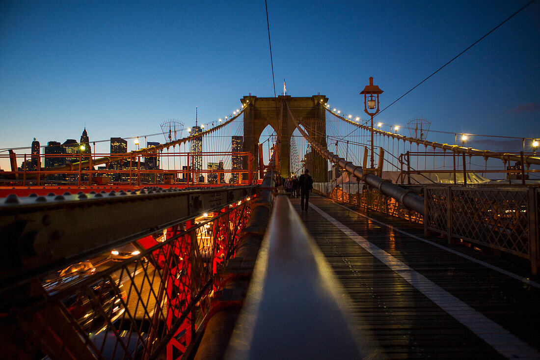 'Pedestrian path on Brooklyn Bridge heading into Manhattan at night; New York City, New York, United States of America'
