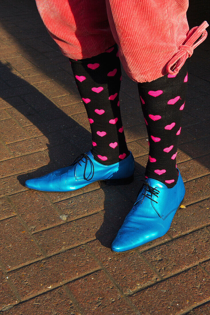 'Bright blue pointed toed shoes, heart socks and short pants, Portobello Road Market; London, England'