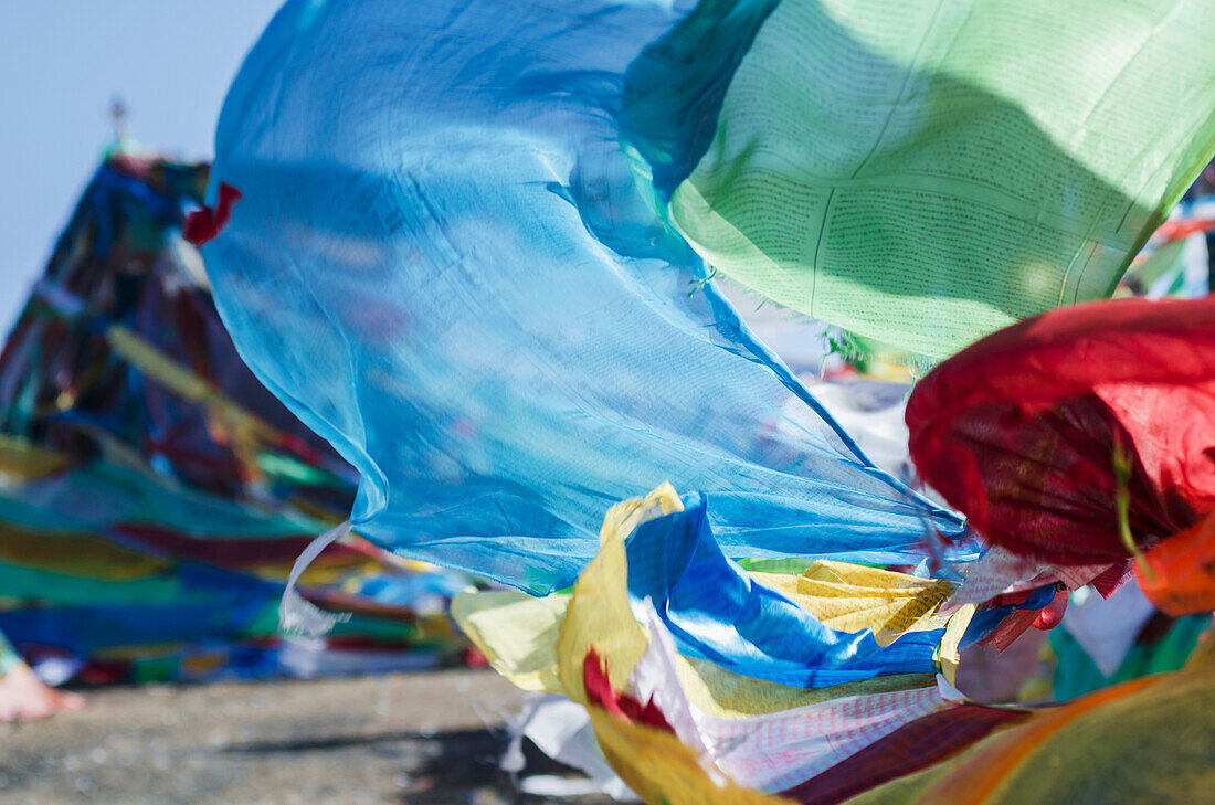 'Blessing colourful Tibetan prayer flags (Lung ta) under the blue sky; Tibet'