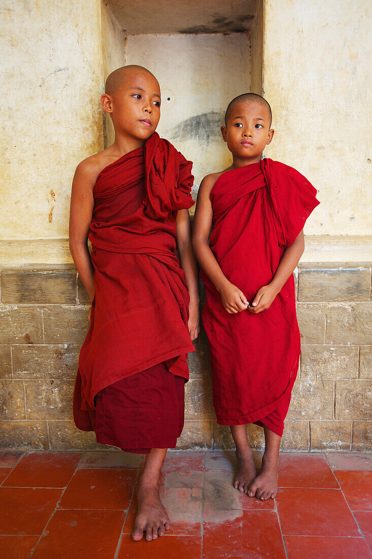 'Two novice monks standing in a Buddhist monastery, Upper Burma; Myanmar'