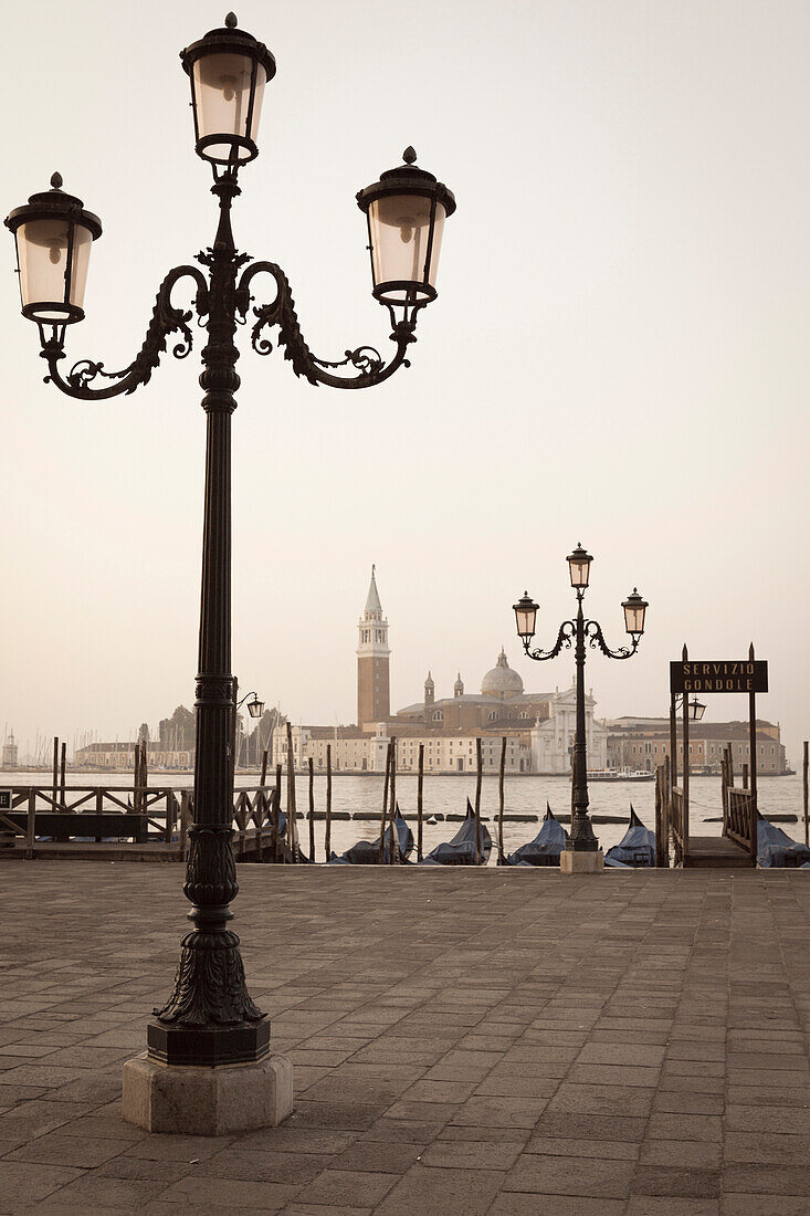 Gondolas moored on the Lagoon, San Giorgio Maggiore beyond, Riva degli Schiavoni, Venice, UNESCO World Heritage Site, Veneto, Italy, Europe