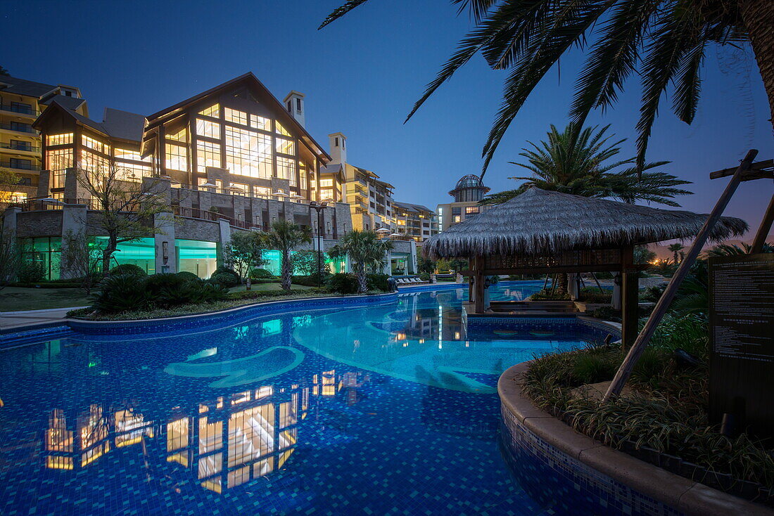 Exterior view of Hilton Hangzhou Qiandao Lake Resort with pool, captured under a full moon, Chun An, Zhejiang, China, Asia