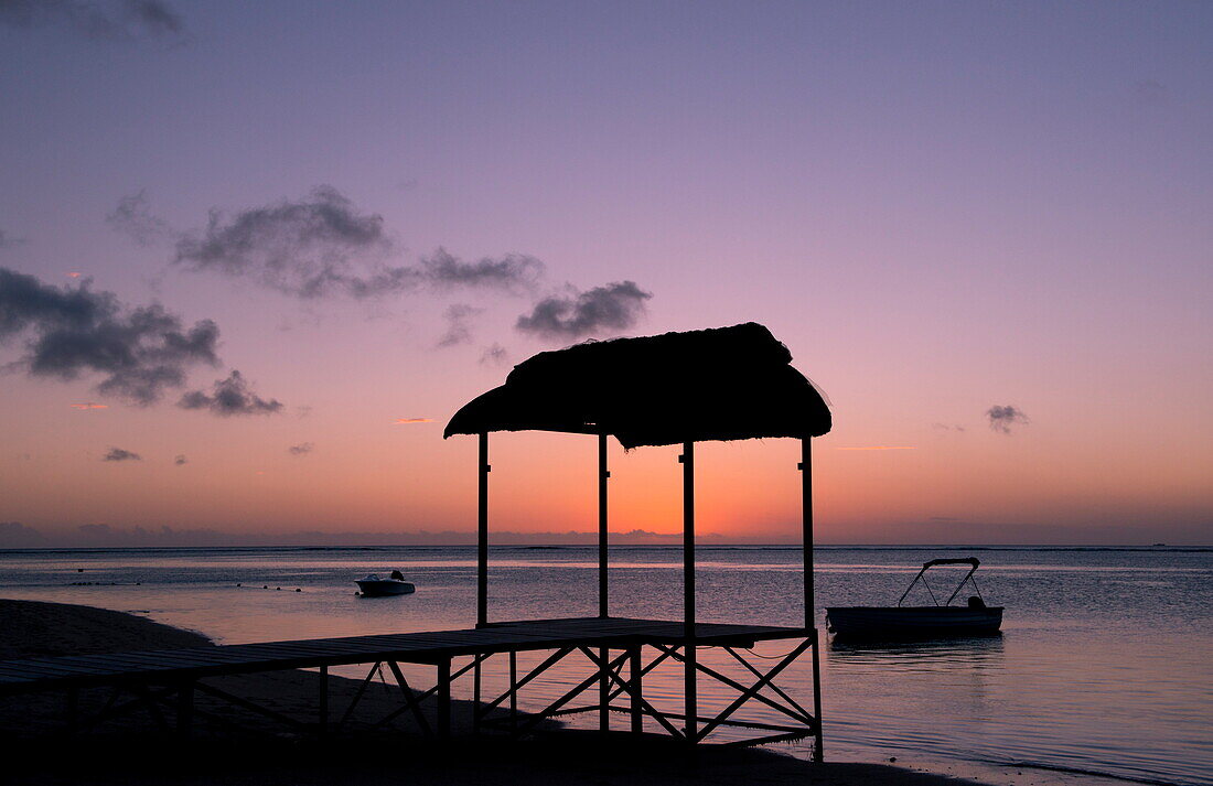 A pier at sunset on the beach of the St. Regis Hotel on Le Morne Brabant Peninisula, south west coast of Mauritius, Indian Ocean, Africa