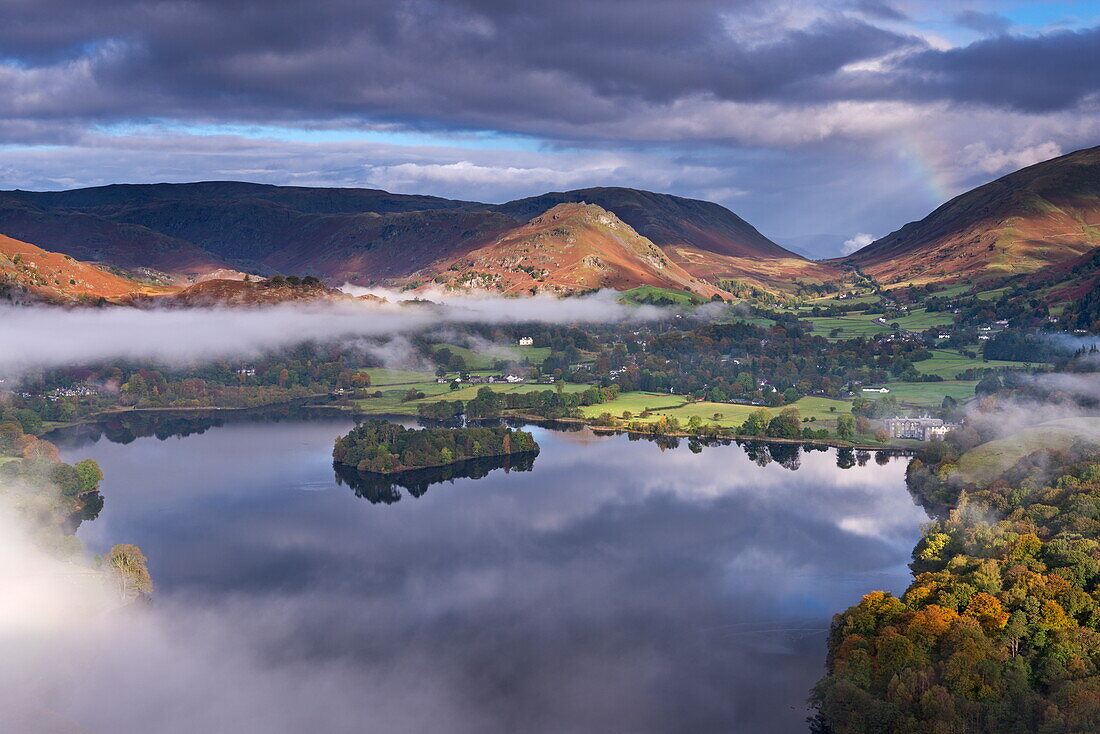 Mist burns off Lake Grasmere in the early morning, Lake District National Park, Cumbria, England, United Kingdom, Europe