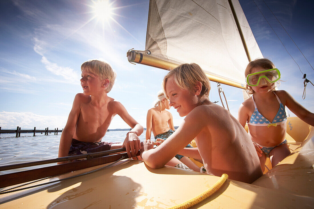 Children in a sailing boat on lake Starnberg, Upper Bavaria, Bavaria, Germany