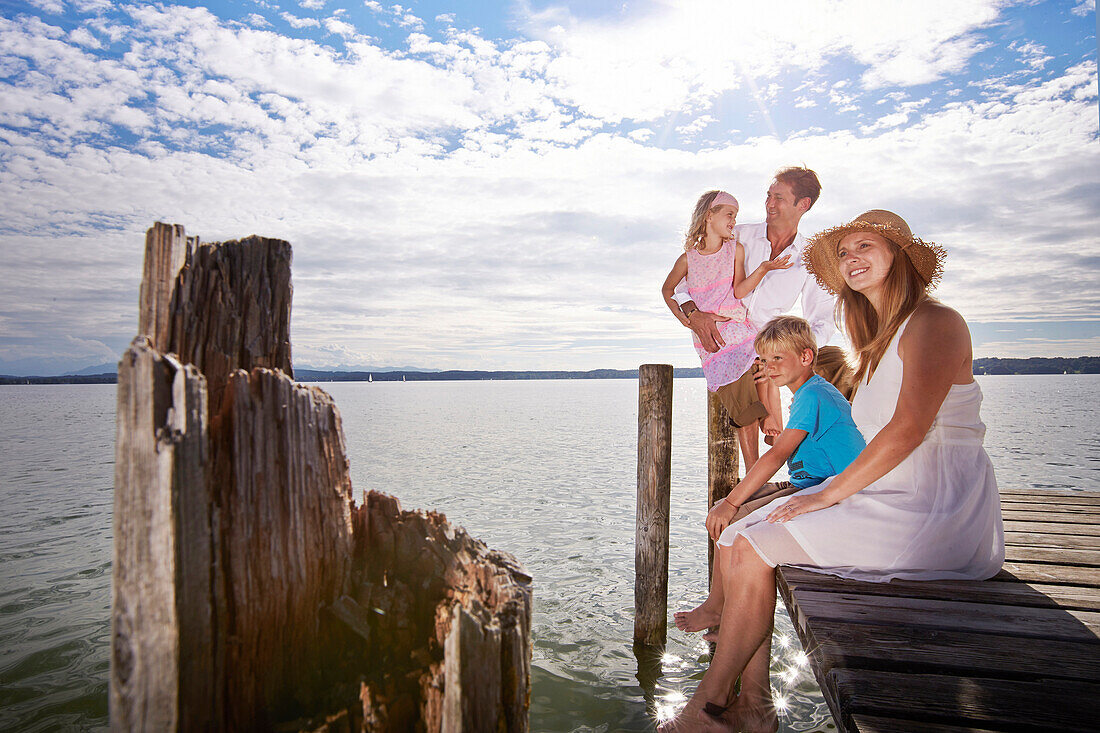 Family on a jetty at lake Starnberg, Upper Bavaria, Bavaria, Germany