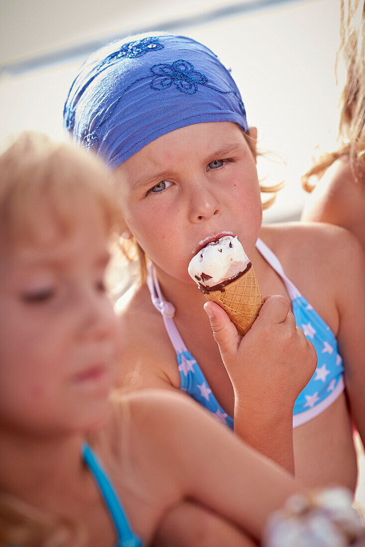 Two girls eating ice cream, lake Starnberg, Upper Bavaria, Bavaria, Germany